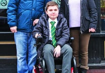 Gaming centre presents Woking teenager with powered wheelchair