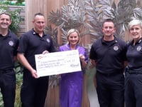 Firefighters present £1000 cheque to hospice
