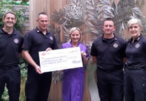 Firefighters present £1000 cheque to hospice