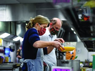 Royals cook lunch and pack supplies at homelessness project