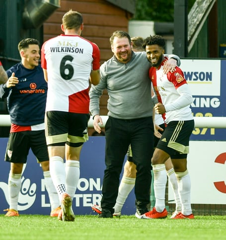 Ricky Korboa celebrates with Woking boss Darren Sarll after scoring against Southend United in October.