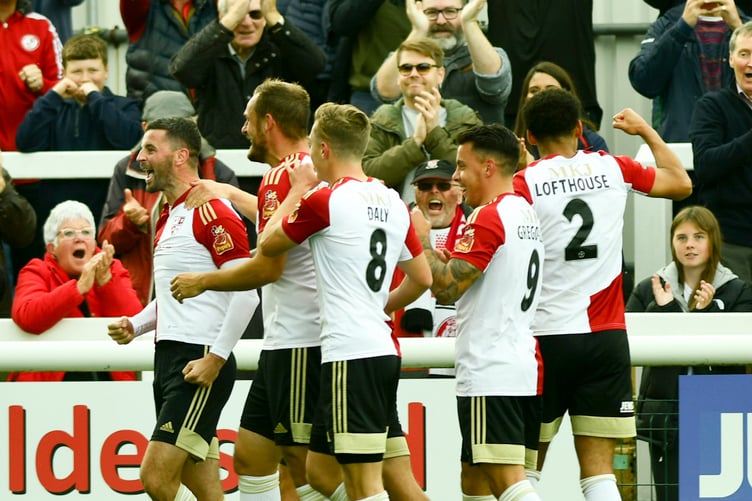 Pádraig Amond being congratulated by his Woking team-mates after scoring against Southend United this season.
