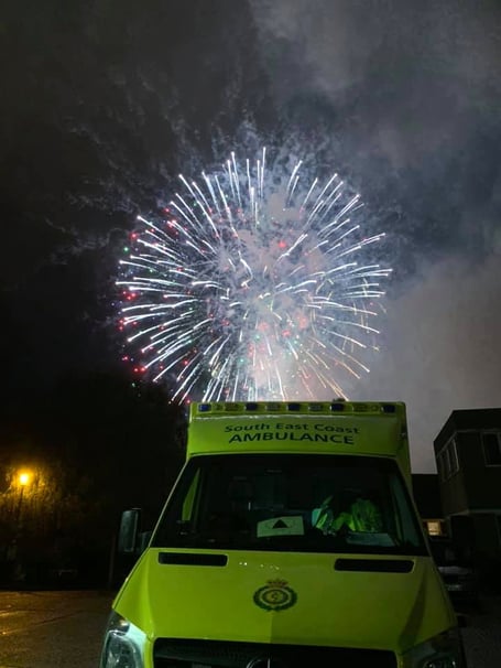 Ambulance lit by firework 