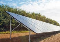 Plans for field of solar panels to power farm office and cottage