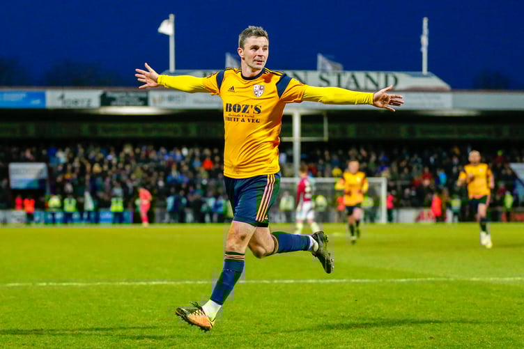 Woking striker Pádraig Amond celebrates after scoring.