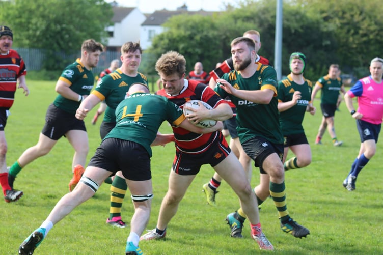 Woking, red and black, tussle with Boyne