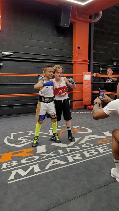 Ayub Mumin, left, and his opponent after the bout in Spain