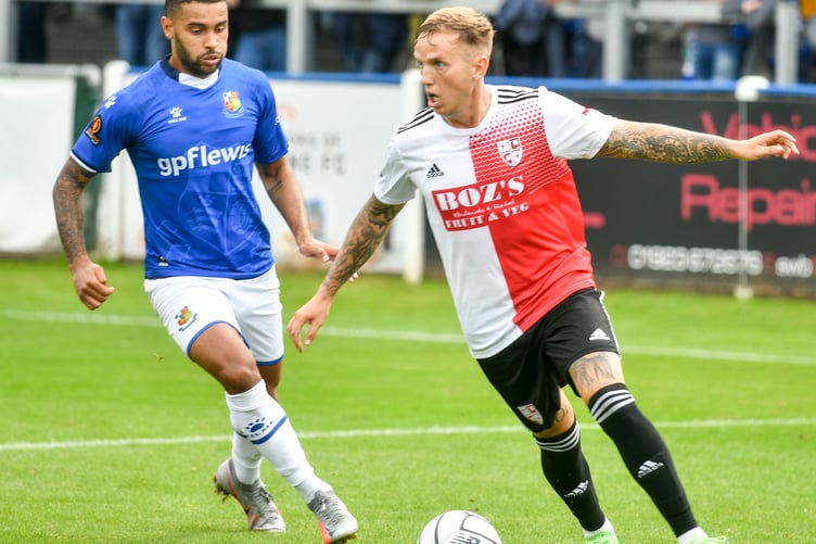 Dennon Lewis, left, in action for Wealdstone against Woking in 2021