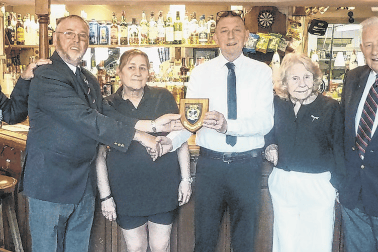 Kay and Ron Major receiving the shield from Keith Tarling (left). Also pictured are Woking Naval Association members Vanessa Lindsay and Mike Richings