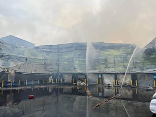 Clients of fire-hit warehouse at Byfleet fear paltry payout terms