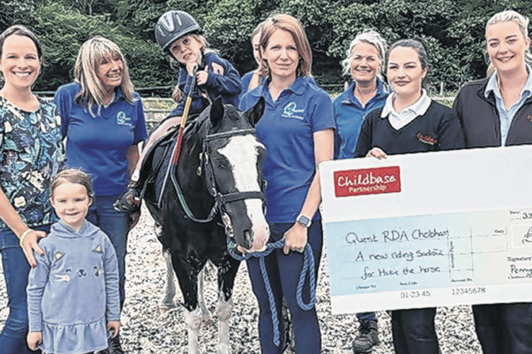 Isla sitting on Hollie in her new saddle, Isla’s mum Nicola, Isla’s sister Hettie, Quest RDA colleagues, Aprille Goubert the charity representative at Pennypot Day Nursery, and Leah Dent of Pennypot