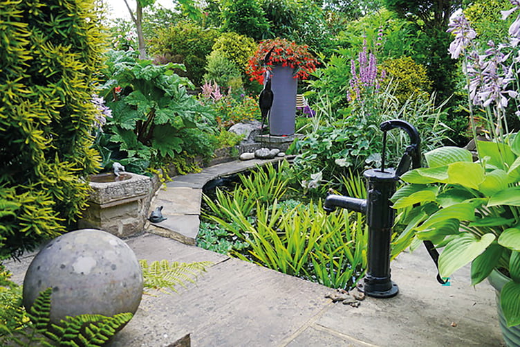 Brian Sale’s garden in Elm Drive, which features shrubs, flowering plants and ornaments around a small pond, won the top prize in Chobham’s annual floral displays contest for the second year running
