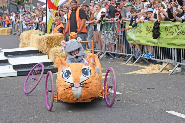 BORDON SOAPBOX
BORDON, HAMPSHIRE
ENGLAND
23rd JULY 2023
On Sunday 23rd July 2023 Whitehill & Bordon in Hampshire was transformed into the ultimate community driven soapbox spectacle, the official Bordon Soapbox Derby
With the main road through the town closed to  traffic the hundreds of spectators were able to walk around the attractions that had been put in place in the early hours of Sunday before gathering many deep on Chalet Hill to watch the 'soapbox racers' take on the challenge to be the fastest competitor to get to the Finish Line ! 
Some of the racers were quick, some were slow, and some driver's after having spectacular spills were permitted to run to the Finish Line as long as they were carrying 'any part of their soapbox' ! 
(Photo by Malcolm Wells)
 
Standard reproduction rates apply, contact Malcolm Wells to arrange payment - Mobile: 07802-217-569 
malcolmrichardwells@gmail.com