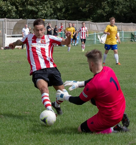 Guildford City’s Jack Knight looks to beat Godalming Town’s keeper last Saturday