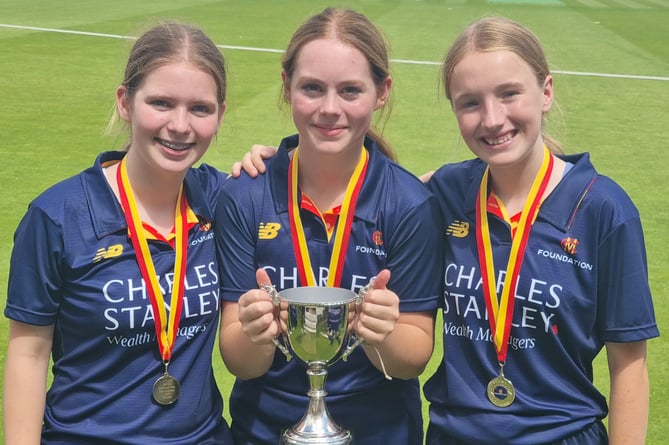Valley End players, from left, Izzy Moors, Abi Shaw-Hales and Amy Williamson with the Marylebone Cricket Club Foundation National Hub Competition trophy after helping Guildford Hub win the final