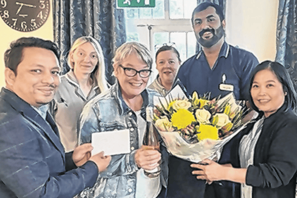A memorable moment for Lesley Wright to celebrate with her colleagues at Coxhills Manor in Chobham