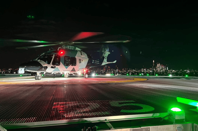 KSS helicopter on Kings College Hospital helipad at night