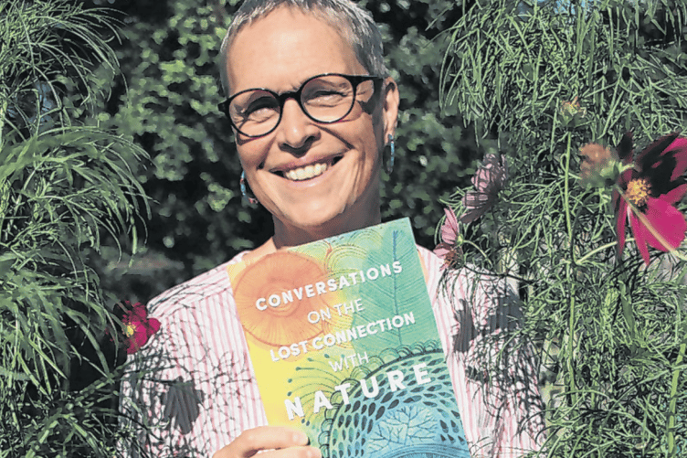 Monique Parker with her book, which examines in depth our relationship with nature