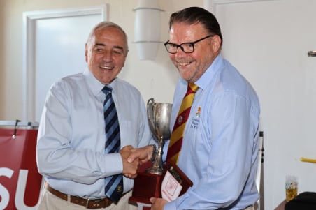 Harry Norman-Walker, right, receiving the trophy after Chobham's Counties One Surrey/Sussex championship win last season