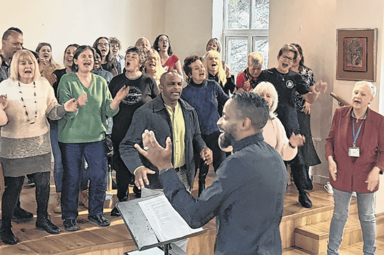 Mark De-Lisser leads a 45-strong group of locals in a moving performance at Saint Columba’s House
