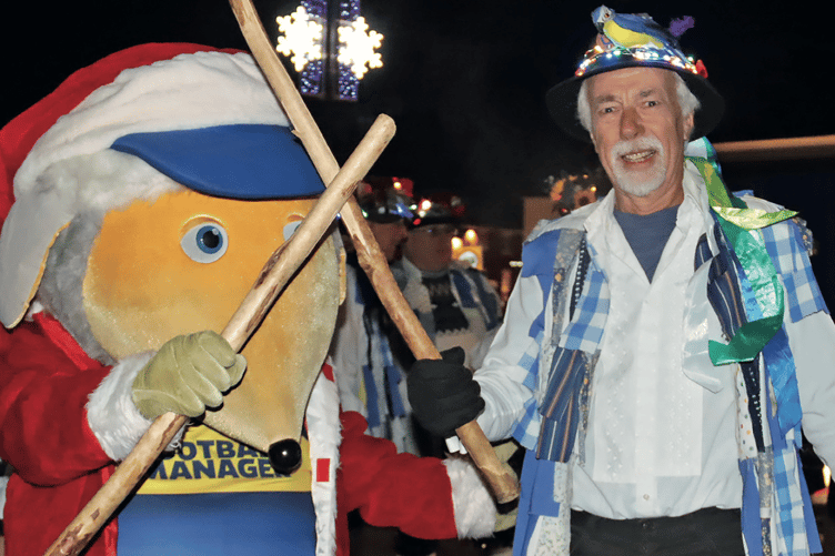 Haydon, the AFC Wimbledon mascot, gets some morris dancing tips from Tim Warren