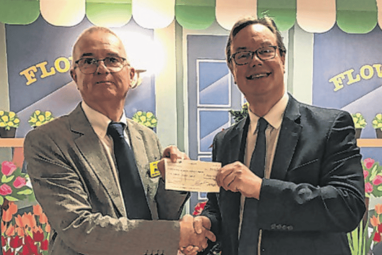 Jonathan Lord MP presenting a £500 cheque to the Friends of Woking Community Hospital donated by the Pyrford Village Show