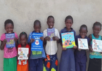 Woking District Rotarians give £2,000 to Africa literacy charity