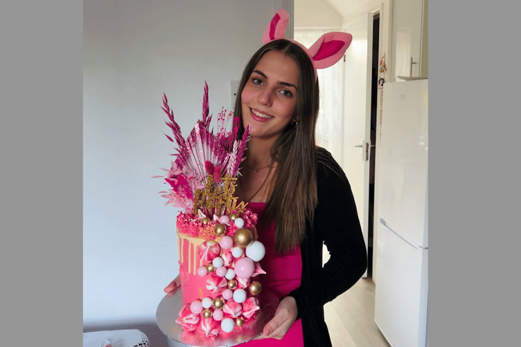 Pearl Alighieri with one of her cakes that she took to a fancy dress party wearing pig ears. She bakes to order and for special occasions