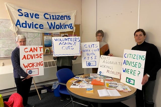 Citizens Advice Woking staff and volunteers prepare their protest banners