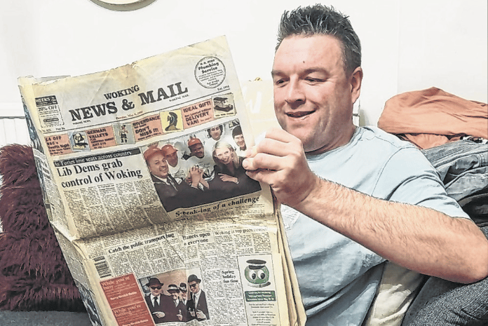 Jon reading a copy of the News & Mail from May 1996