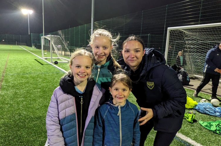 Oxford United player Jamie Gooch with girl footballers at Goldsworth Park Rangers, March 8th 2024.