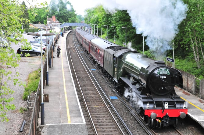 The world famous locomotive Flying Scotsman, with The Cathedral Express mainline special, steams through Worplesdon station
