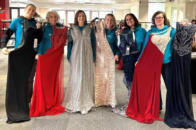 Woking & Sam Beare Hospice staff with donated Prom dresses