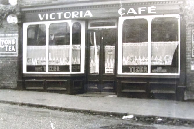 The Victoria Cafe. Note the advertising sings for Lyons Tea and Tizer!