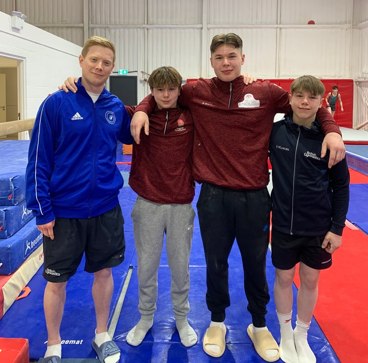 Woking Gymnastics Club coach Craig Woodhams with Josh, Oli and Ben Porter, April 2024.