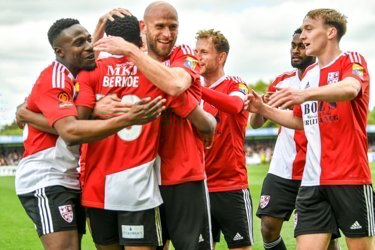 Kevin Berkoe is congratulated after scoring Woking's third goal (Photo: Woking FC)