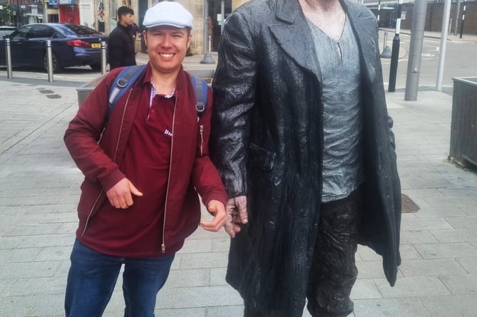 Jon Andrews's friend Alex with one of the Sean Henry statues in Woking town centre