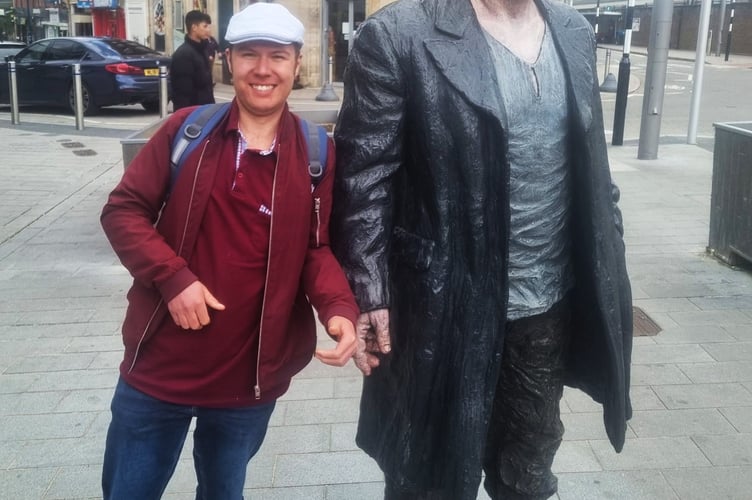 Jon Andrews's friend Alex with one of the Sean Henry statues in Woking town centre