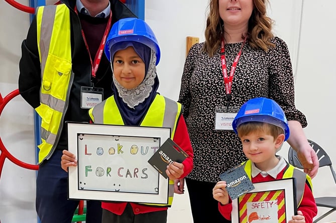 Tooba Syed  and Henry Jobson from Lakeside Primary School, in Deepcut with Matt Jenkins, Bewley Homes health and safety manager and Chloe Willman, Bewley's head of customer experience