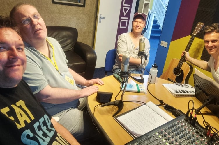 Jon Andrews with Shay and Alex, who are helped by the   Sunnybank Trust, and Simon Fidler,  a musician