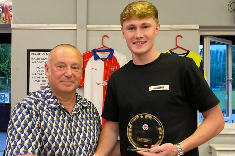 Aaron Burchett (right) receives the supporters’ player award from Paul Hopkins (Photo: Knaphill FC)