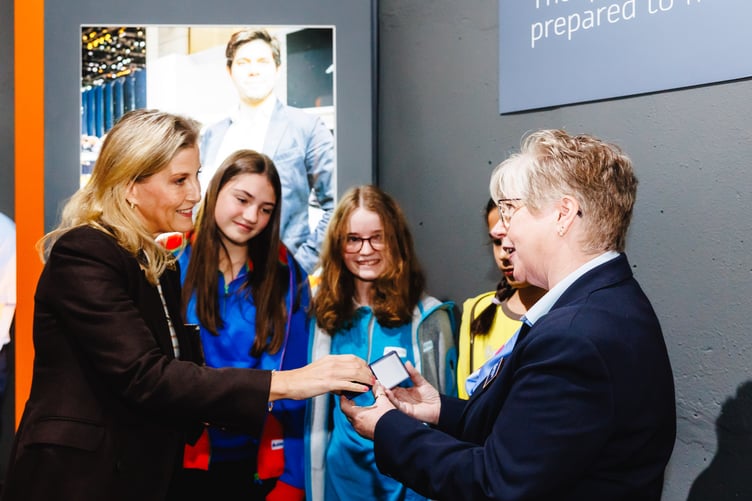 Left to right: HRH The Duchess of Edinburgh, being presented a rose gold Girlguiding Patron badge by Guide Katie, Ranger Elysia, Brownie Amelia and Chief Guide, Tracy Foste