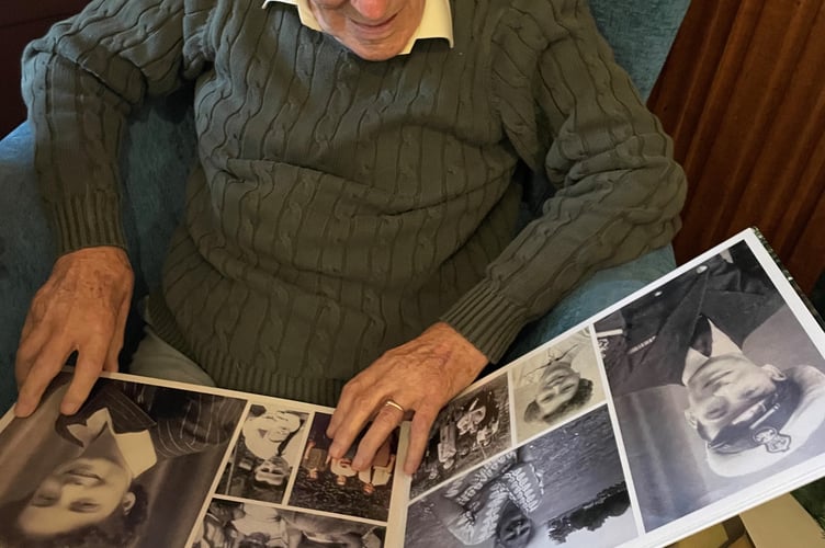 Reg looks through an album of his life