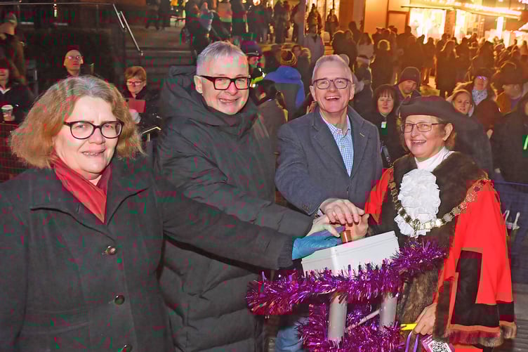 From left, Cllr Ann-Marie Barker, leader of Woking Borough Council, Christopher Biggins, Cllr Dale Roberts, and Deputy leader and mayor of Woking, Cllr Louise Morales, at the town's Christmas light switch-on