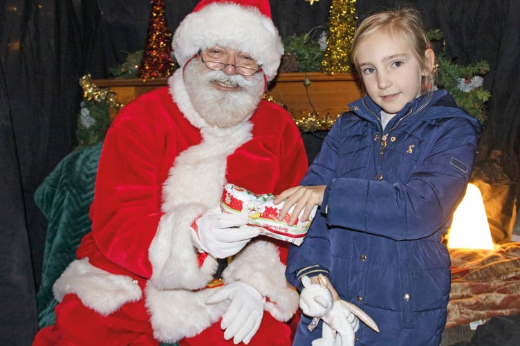 Rosie Barnes, aged six, meets Father Christmas in the Friends of St Lawrence grotto.
