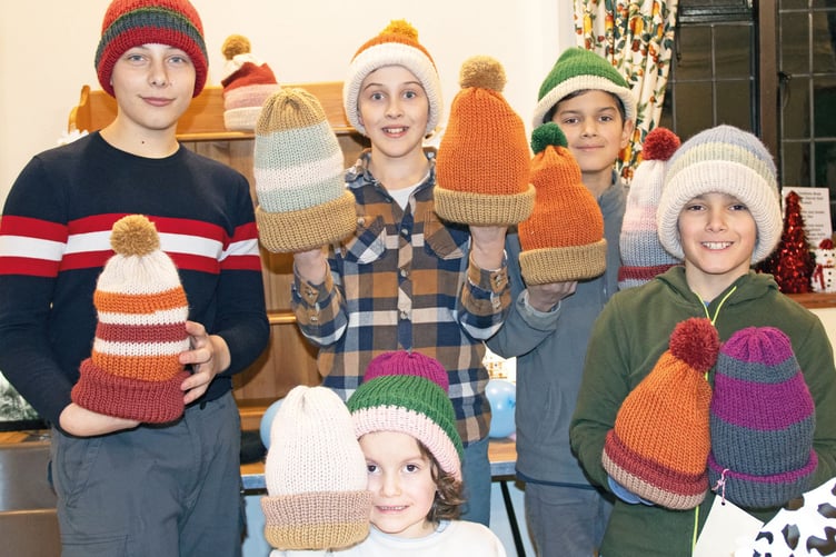 Zac, Caleb, Arthur, James and Eva set up a stall in the church hall to sell woolly hats they had made as young enterprise.