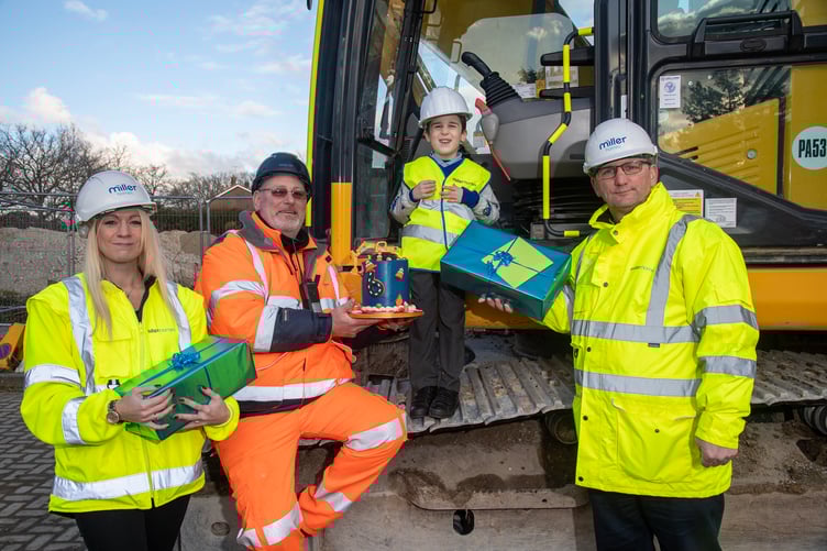 Louie Thomas on a digger, alongside (left to right), Laura Worley, Miller Homes Southern marketing manager, John Nuthall, site manager from Collard Contracting, and Paul Coombes,  Miller Homes Southern production director