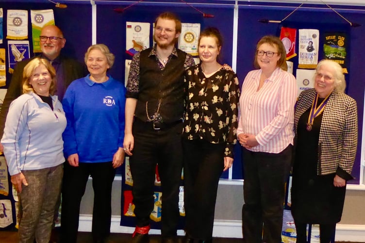 Woking Rotary members and charity representatives gather for the cheque presentation