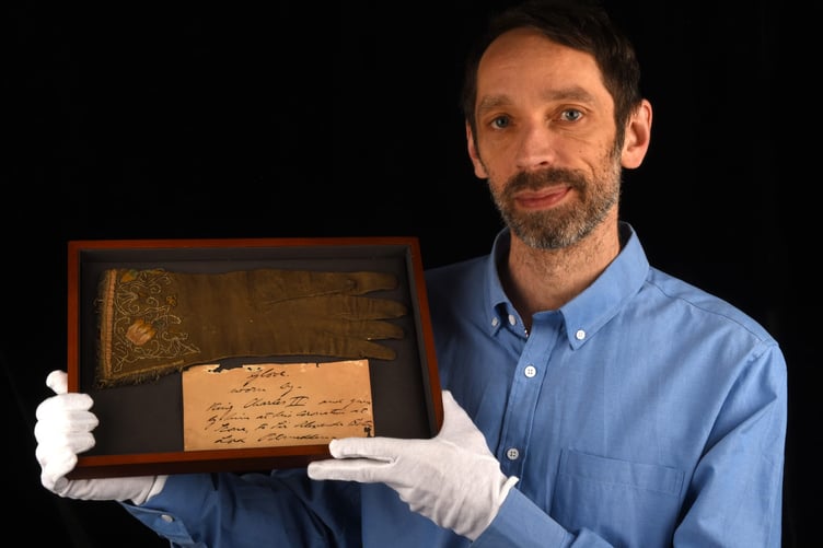 Andrew Ewbank holding Charles II, Coronation Glove. (Ewbank's Auctions)