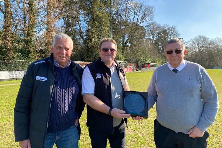 Phil Kelsey and Bob Dalling from the Combined Counties Football League presented the award to Knaphill chairman Chris Drane (Photo: Knaphill FC)